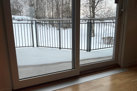 Villa i Holmestrand. E-100 med ramme nedfelt i parkett foran terrassedør. Farge eloksert aluminium (standard).